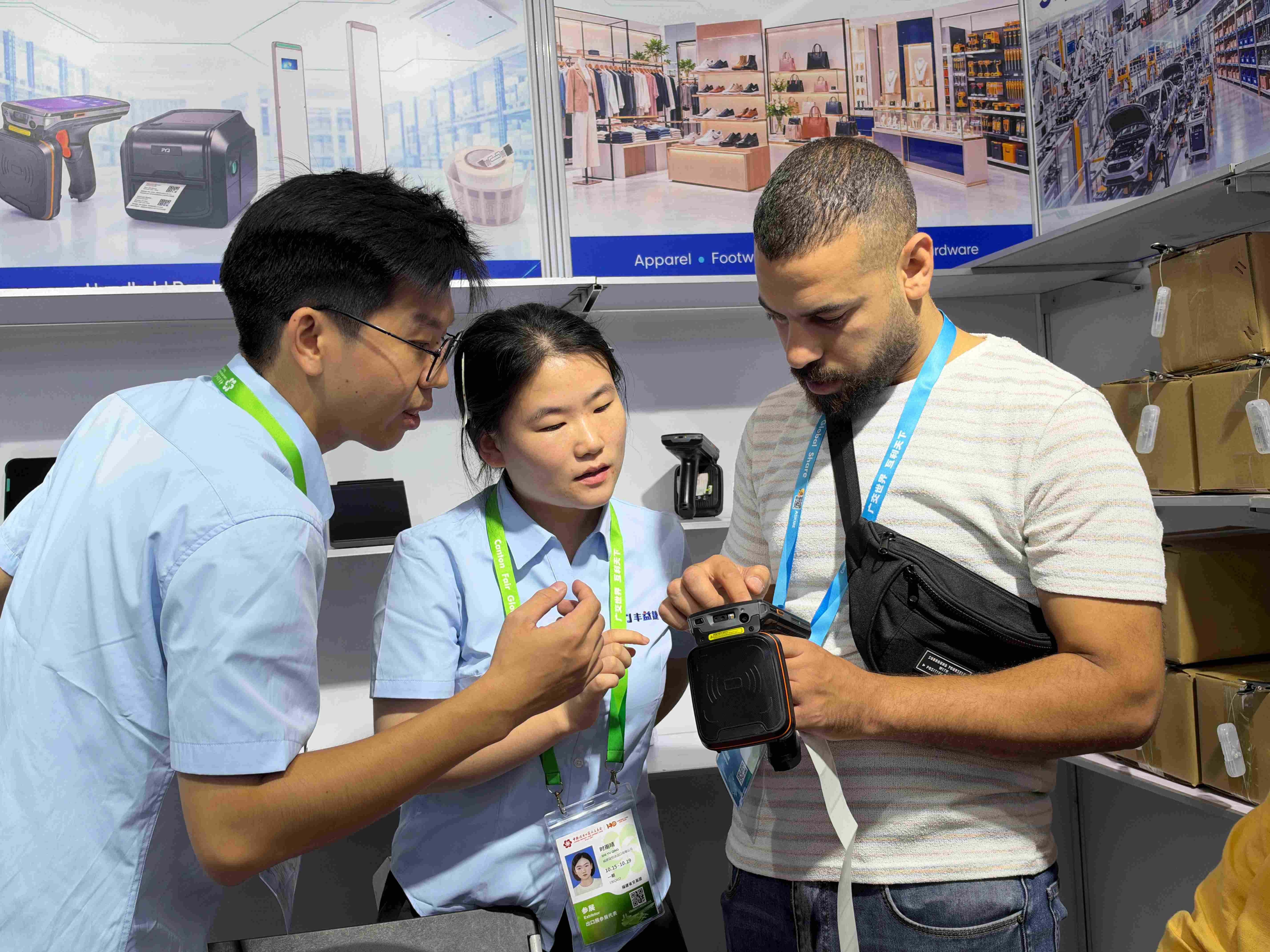 Hands-On RFID PDA Testing Visitor testing an RFID handheld PDA for batch tag reading and packaged goods identification at the FYJ booth